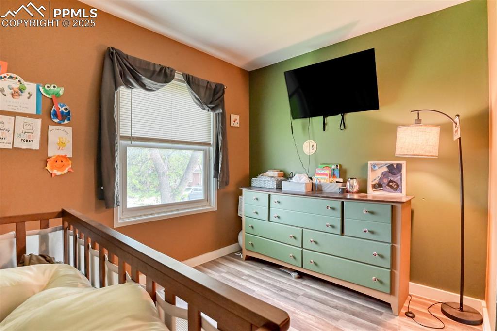 Image 30 of 37: Bedroom with baseboards and light wood-type flooring