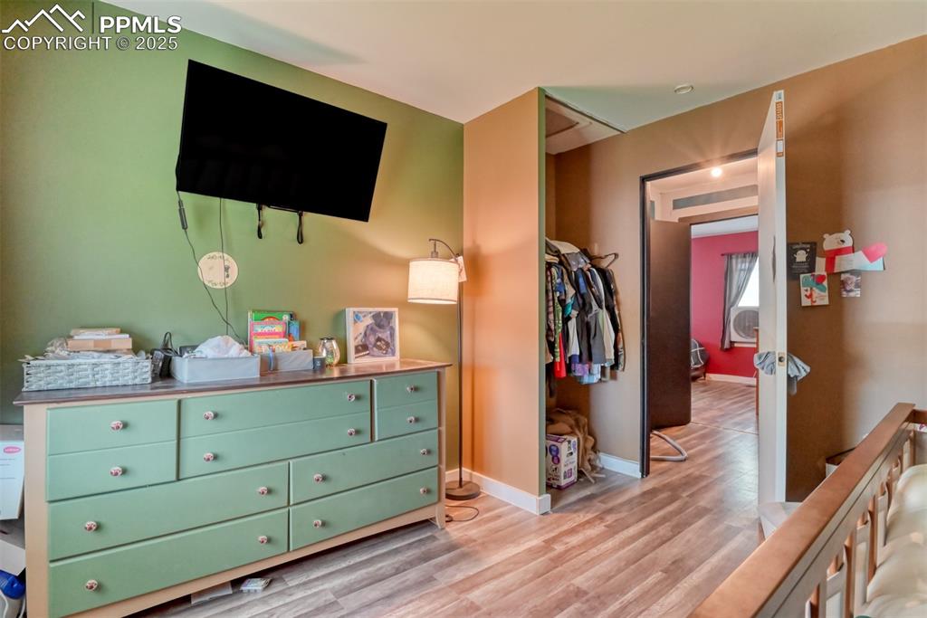 Image 32 of 37: Bedroom featuring baseboards and light wood-style flooring