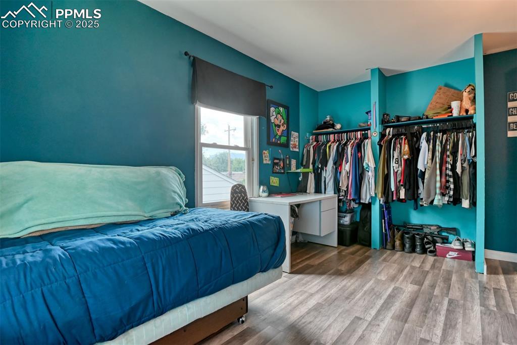 Image 36 of 37: Bedroom with wood finished floors