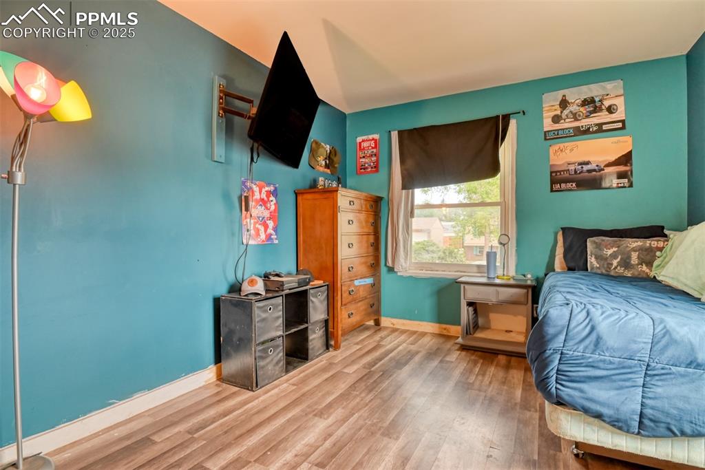 Image 37 of 37: Bedroom featuring baseboards and wood finished floors