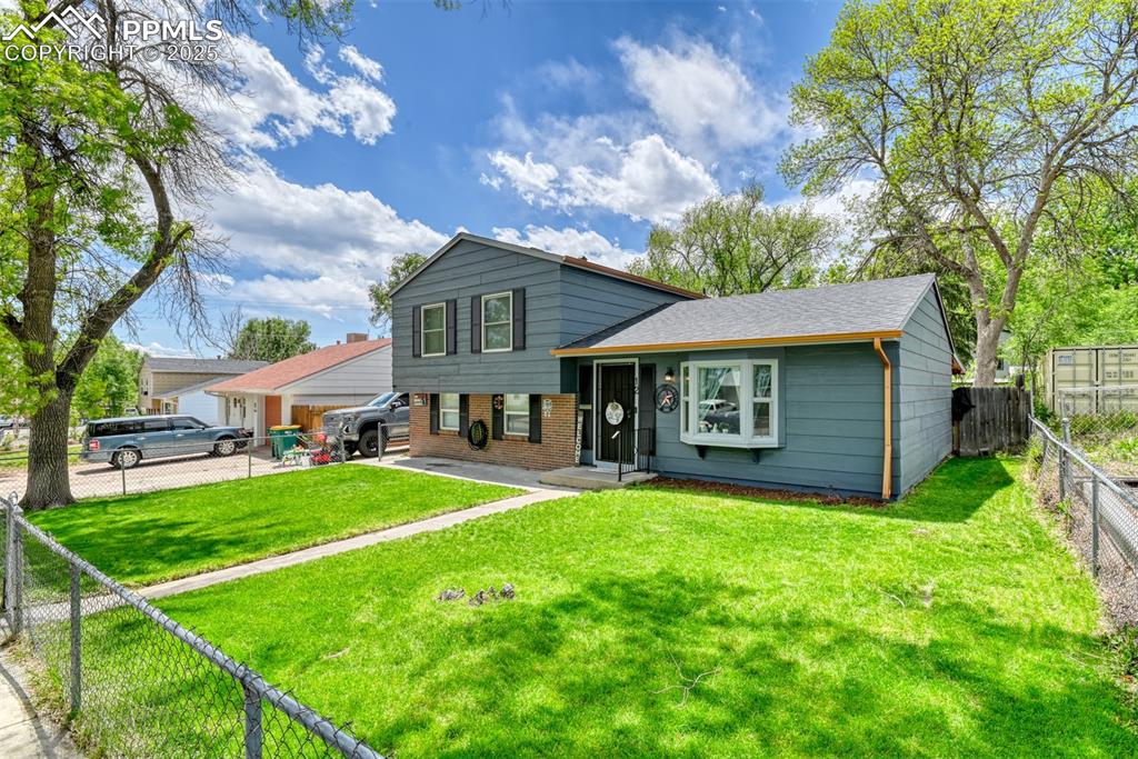 Image 4 of 37: Tri-level home featuring brick siding and roof with shingles