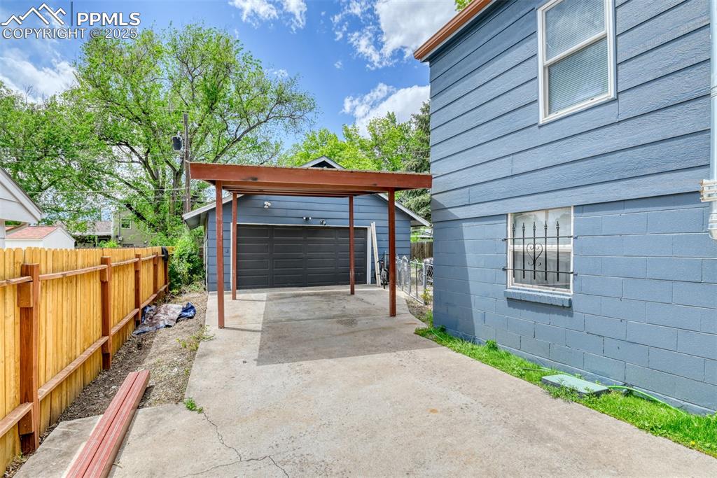 Image 6 of 37: View of patio with an outbuilding and a garage