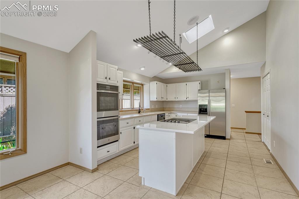 Image 15 of 49: Vaulted Tiled Island Kitchen, Skylight