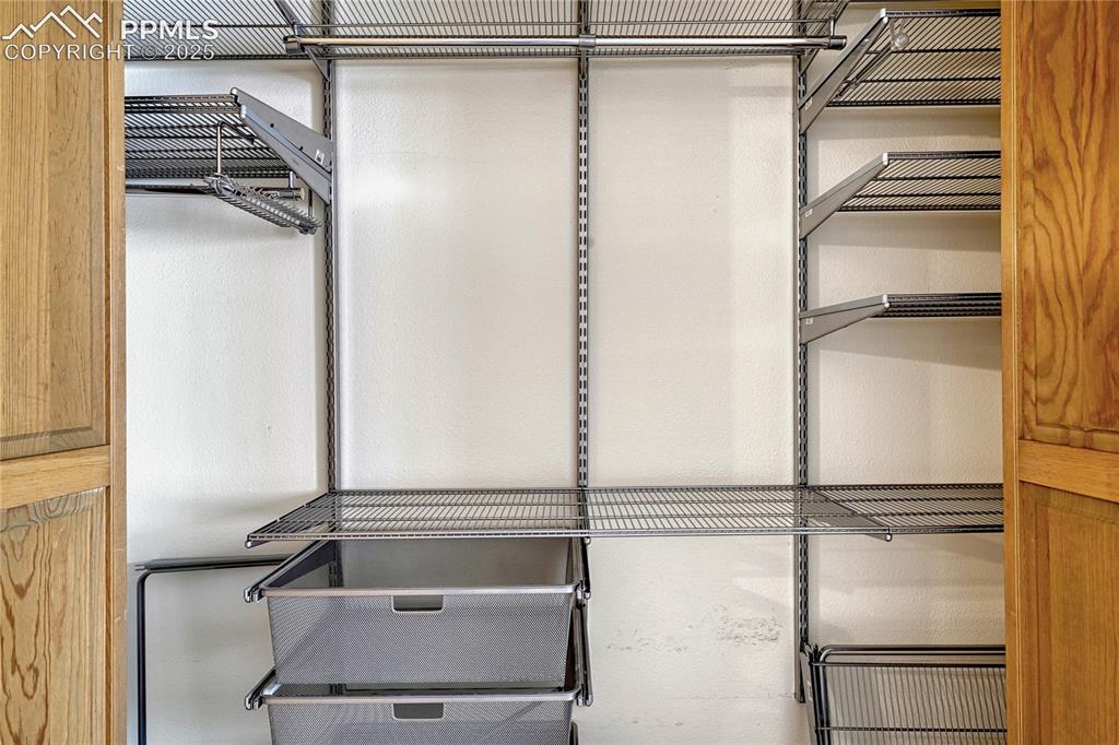 Image 19 of 49: Two Walk-in Closets, One with Elfa Shelving