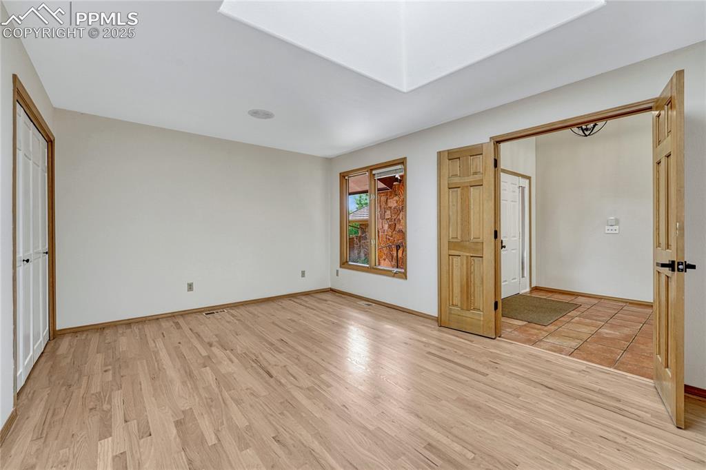 Image 22 of 49: Large Office off Main Entry, Double Doors, Closet & Hardwood Floors, Could