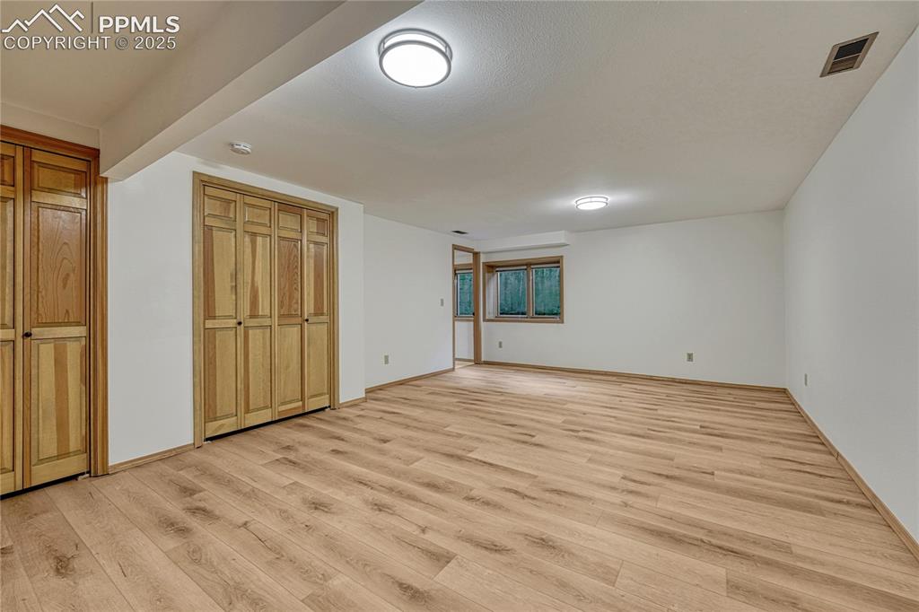 Image 29 of 49: Large 3rd Bedroom, All New LVT Floors, New LED Light Fixtures, New Paint, A