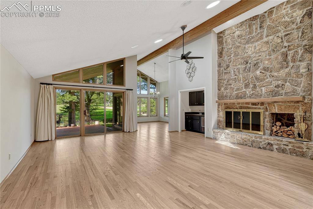 Image 40 of 49: Vaulted Ceilings, Large Moss Rock Stone Fireplace