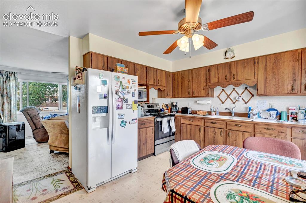 Image 4 of 26: Kitchen includes refrigerator and oven
