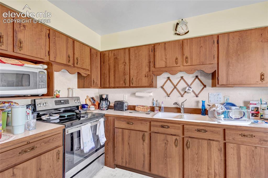 Image 7 of 26: Kitchen has beautiful cabinets galore with tasteful hardware