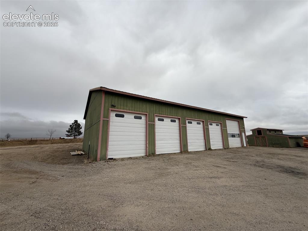 Image 46 of 50: Garage and Barn behind Garage