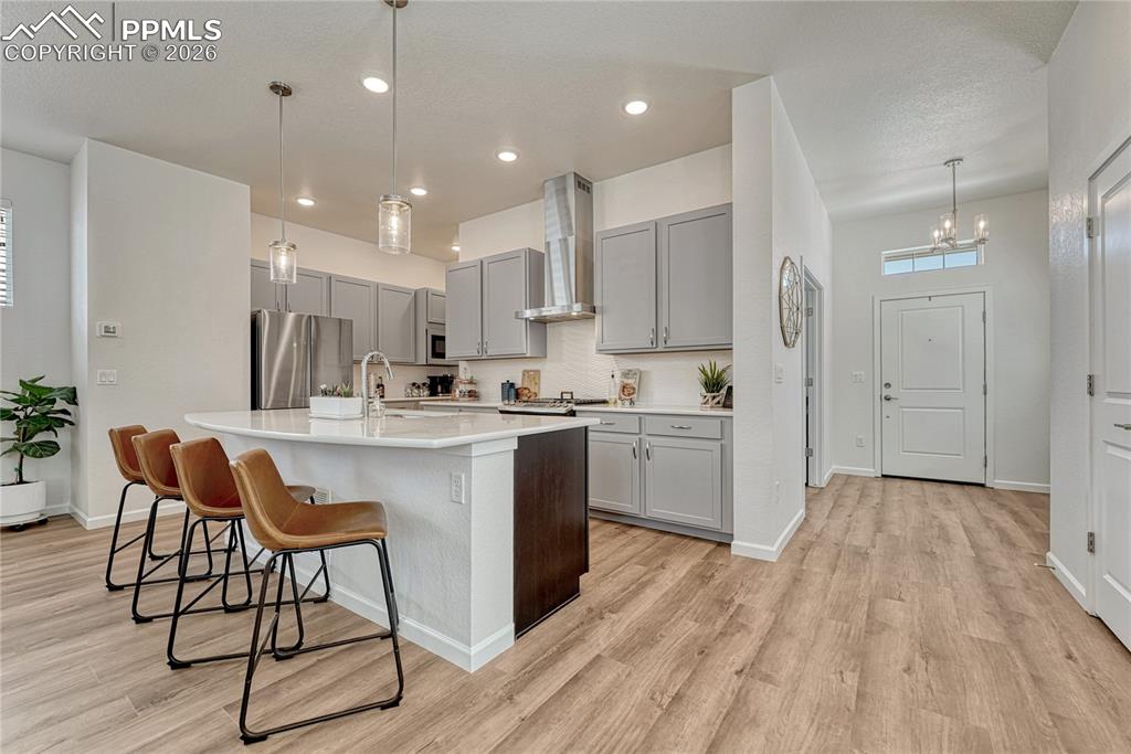 Image 12 of 50: Light grey perimeter tall cabinets and contrasting dark cabinets for the is