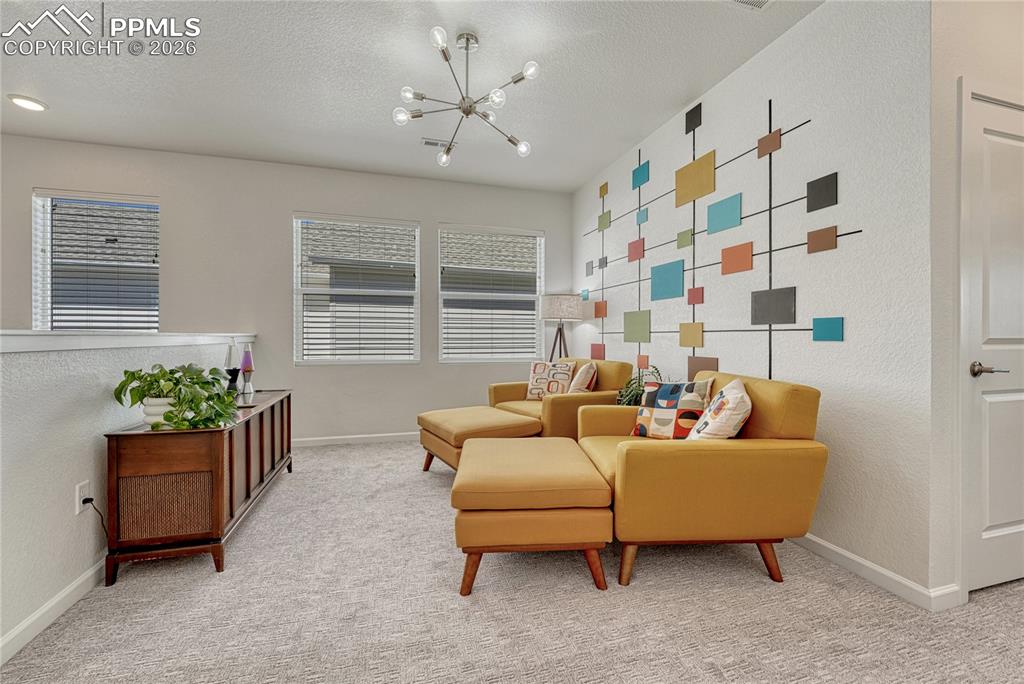 Image 20 of 50: Head upstairs to a large loft space that could be used as a sitting area, o