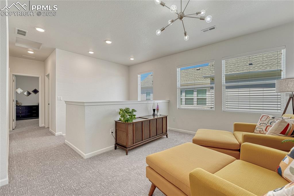 Image 30 of 50: The loft helps separate the upper rooms for privacy but adds an opportunity