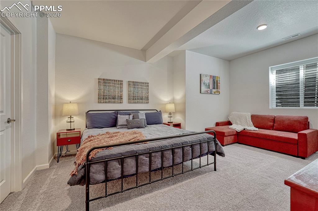 Image 40 of 50: Off the large family room is a over-sized bedroom with space for a sitting