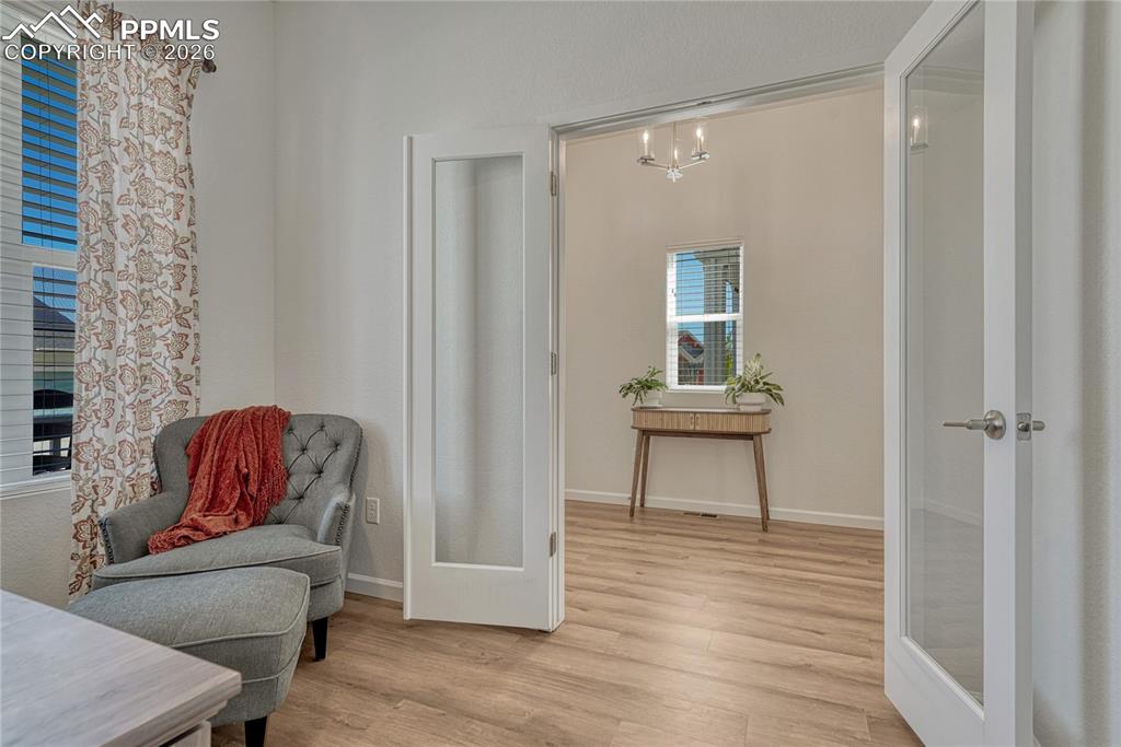 Image 6 of 50: The office is separated by the rest of the home with glass french doors