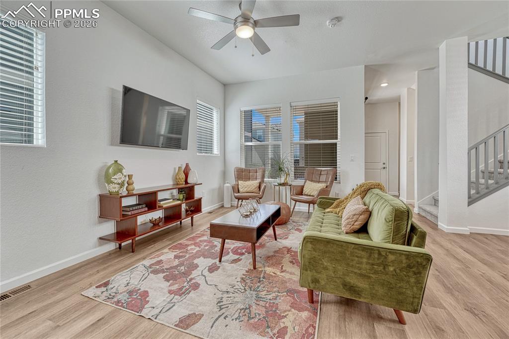Image 8 of 50: The living room connects the dining space and kitchen on the main level