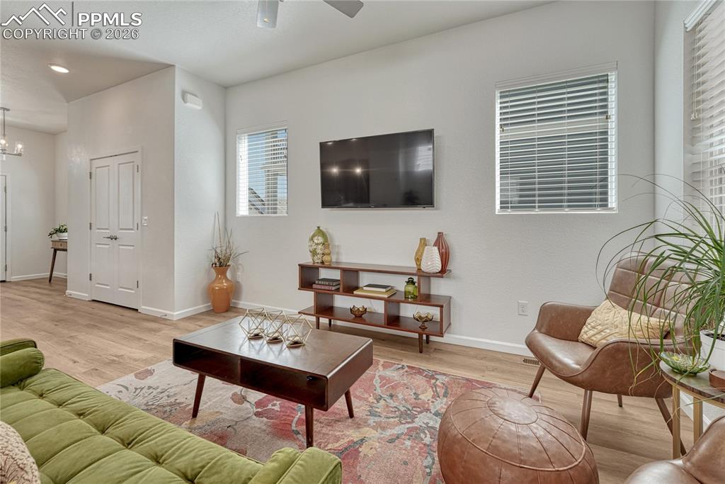 Image 9 of 50: Large windows and tall ceilings allow the space to fill with light and real