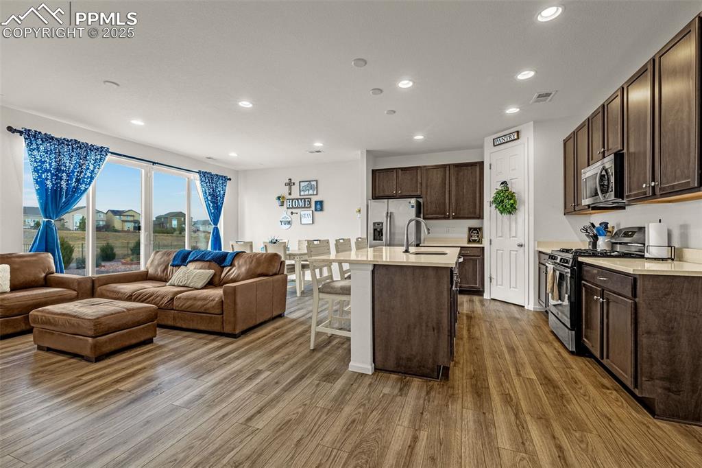 Image 15 of 37: Kitchen featuring stainless steel appliances, recessed lighting, dark brown