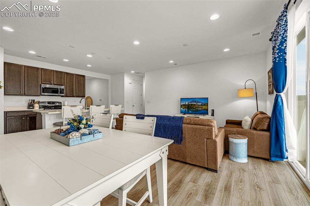 Image 17 of 37: Dining area with recessed lighting and light wood finished floors