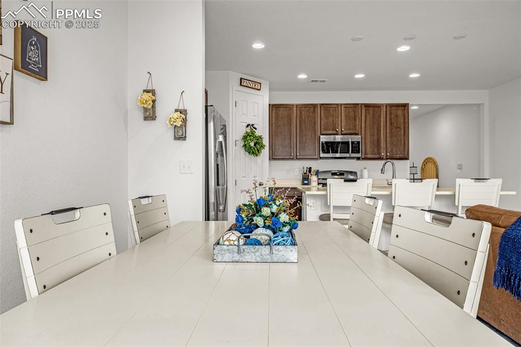 Image 19 of 37: Kitchen featuring light countertops, recessed lighting, appliances with sta
