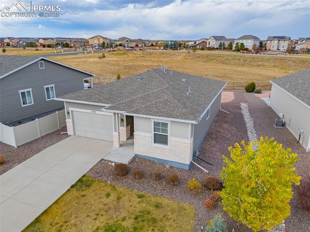 Image 2 of 37: Traditional-style house with roof with shingles, concrete driveway, an atta