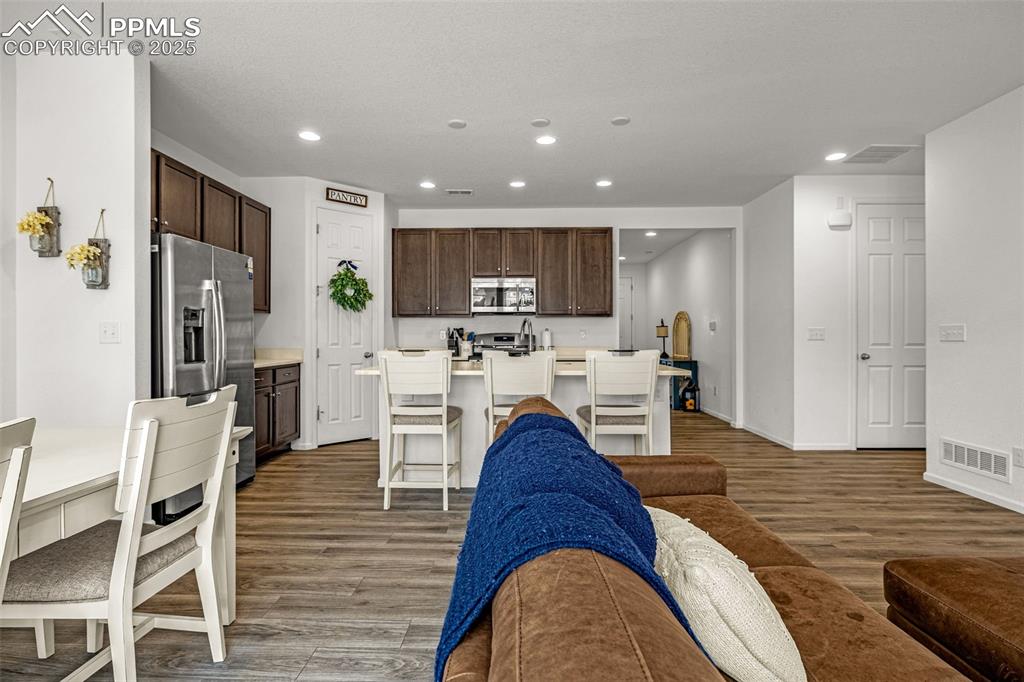 Image 21 of 37: Living room featuring recessed lighting and dark wood-style flooring