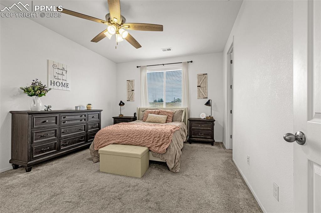 Image 23 of 37: Bedroom featuring light carpet and a ceiling fan
