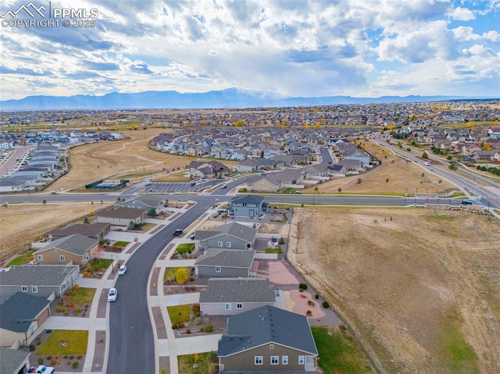 Image 30 of 37: Aerial perspective of suburban area featuring a mountain backdrop