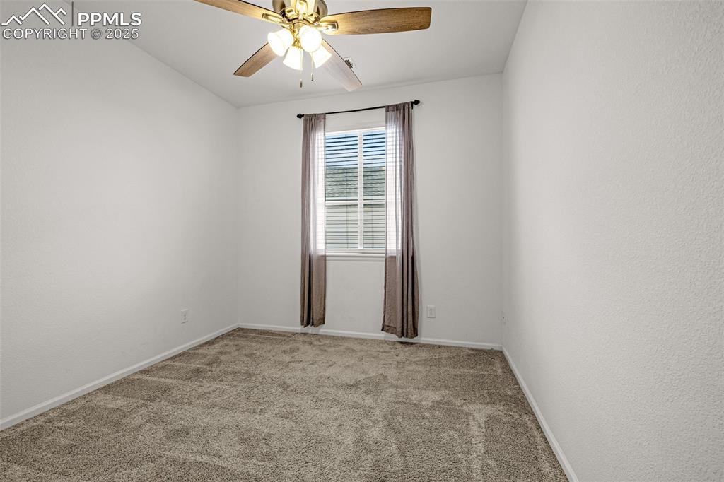 Image 9 of 37: Unfurnished room with light colored carpet and ceiling fan