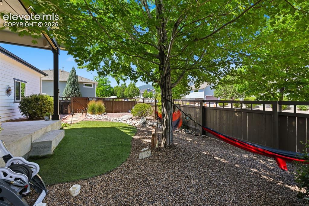 Image 10 of 46: Covered Patio/Landscaping
