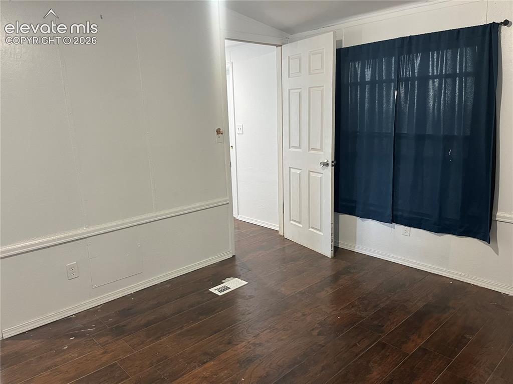 Image 11 of 14: Wood-finish flooring with a dark stain