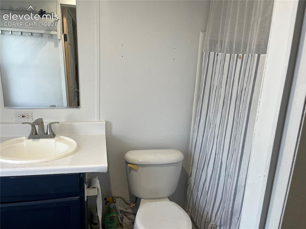 Image 12 of 14: Bathroom vanity with integrated sink, brushed nickel faucet, and under-sink