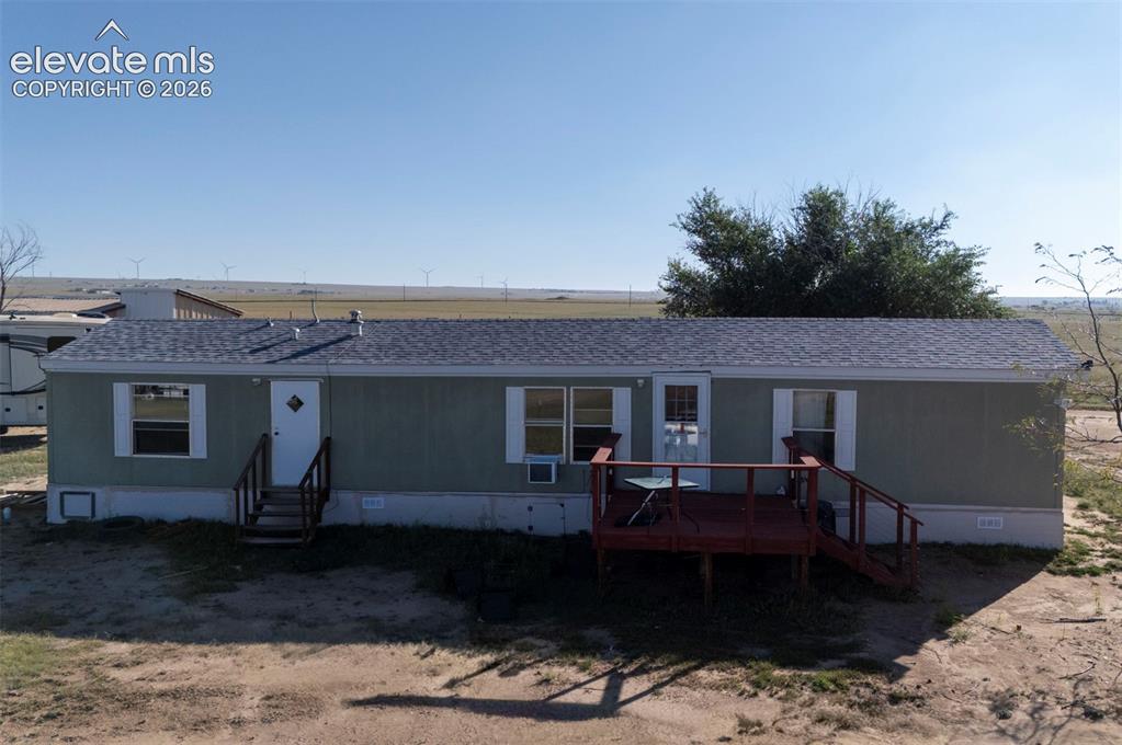 Image 2 of 14: Exterior featuring a gray shingle roof, light green siding, white trim wind