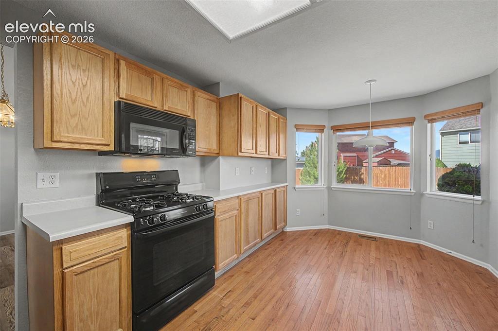 Image 8 of 17: Solid hardwood flooring, oak cabinets 