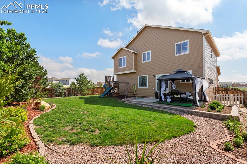 Image 34 of 43: Covered patio and play set are included!