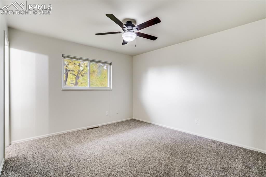 Image 15 of 44: Primary bedroom with ceiling fan