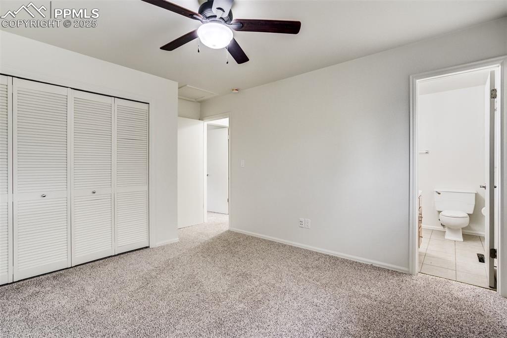 Image 16 of 44: Nice long wall closet and adjacent 1/2 bath in primary bedroom