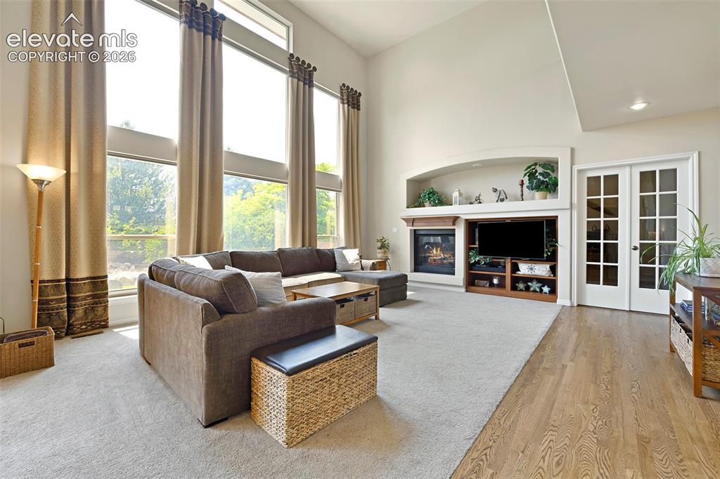 Image 16 of 46: Family Room has double sided gas fireplace shared with
