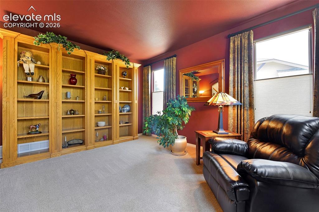 Image 7 of 46: to the Formal Living Room with Built-in shelves...