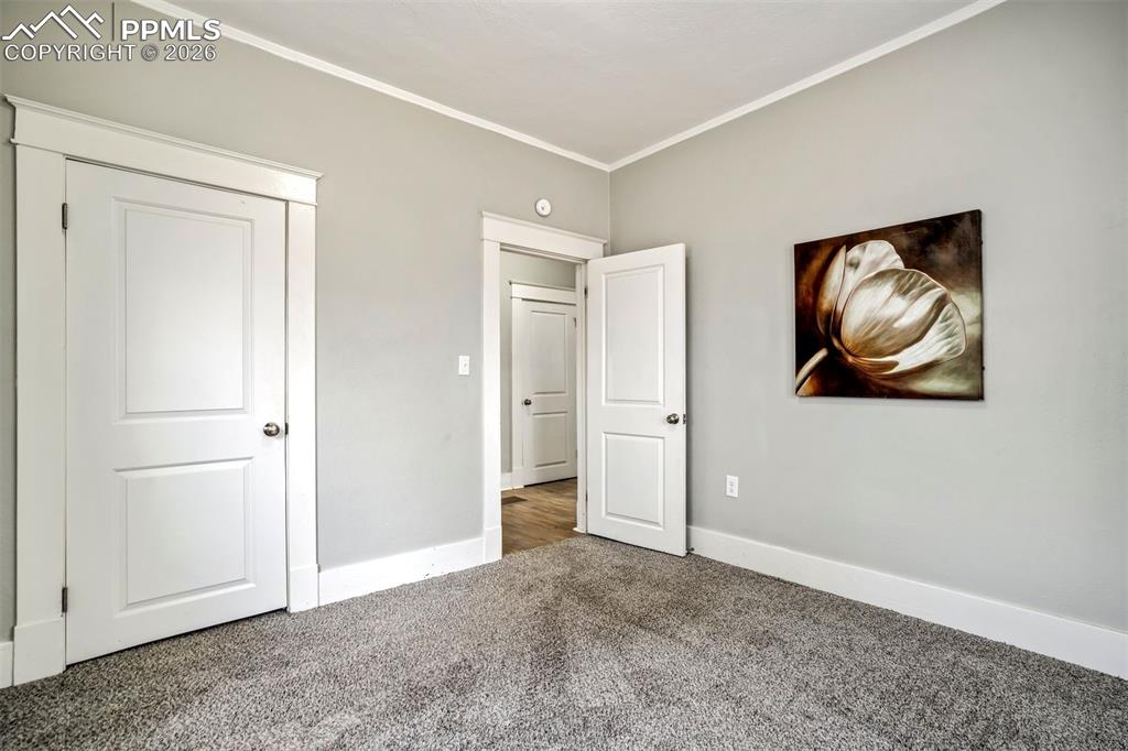 Image 11 of 38: Spacious bedroom with updated flooring and soft, neutral tones. Multiple wi