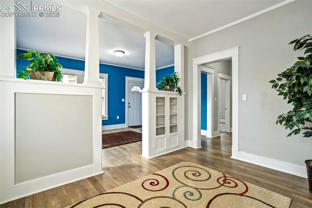 Image 16 of 38: Charming open living and dining space highlighted by beautiful built-in cab