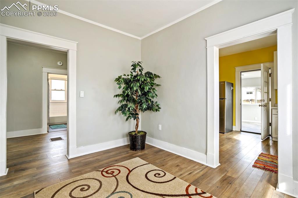 Image 17 of 38: Light-filled dining space with updated flooring and neutral tones, offering