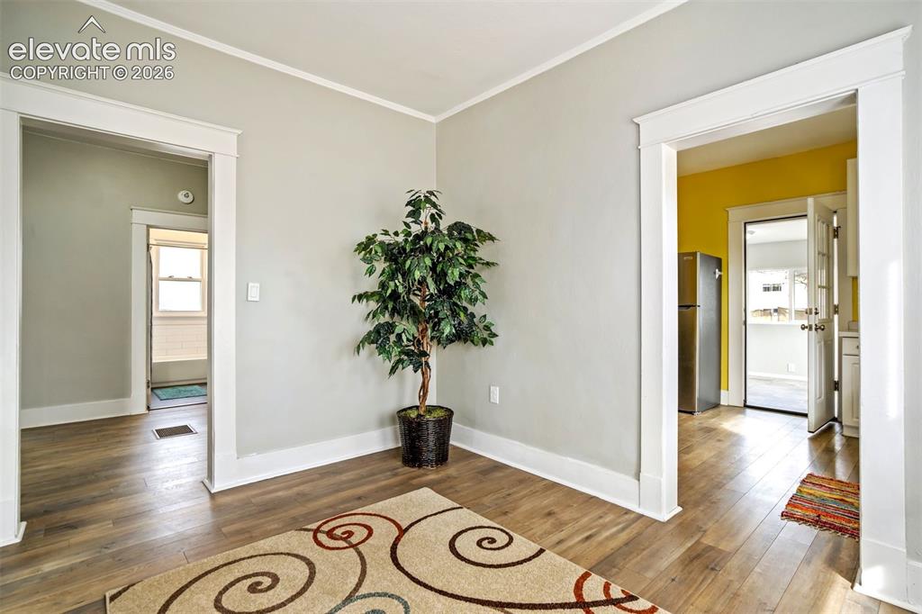 Image 19 of 36: Light-filled dining space with updated flooring and neutral tones, offering