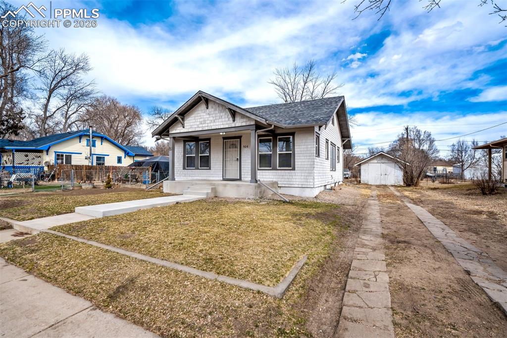 Image 2 of 38: Charming bungalow-style home with inviting covered front porch and classic