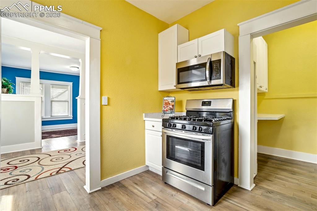 Image 23 of 38: Well-designed kitchen with space for casual dining or coffee nook. Clean fi