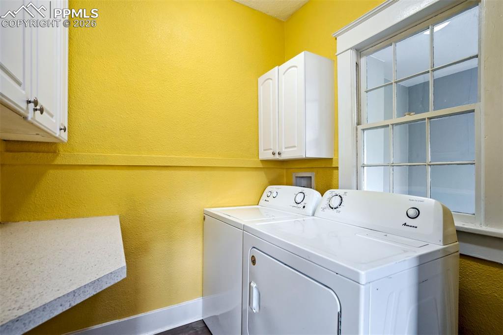 Image 27 of 38: Convenient main-level laundry area with washer and dryer included, along wi