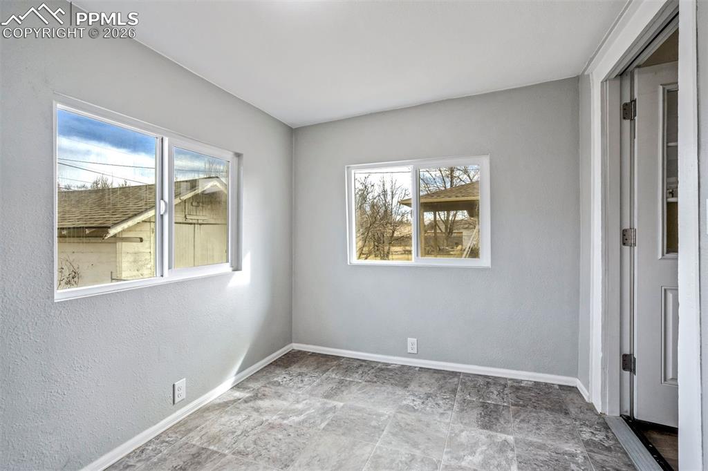 Image 28 of 38: Bright and versatile sunroom filled with natural light from multiple window