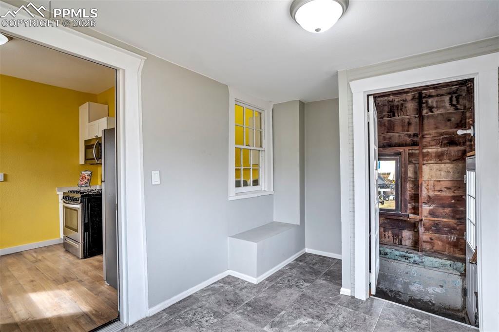 Image 29 of 38: Light-filled bonus space conveniently located off the kitchen, ideal for ca