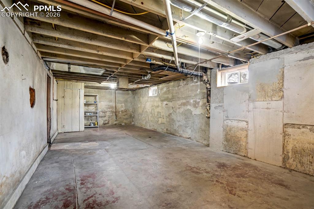 Image 30 of 38: Multiple basement spaces provide flexibility for workshop, storage, or hobb