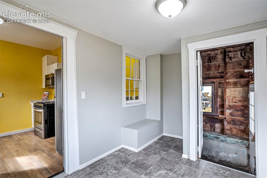 Image 31 of 36: Light-filled bonus space conveniently located off the kitchen, ideal for ca